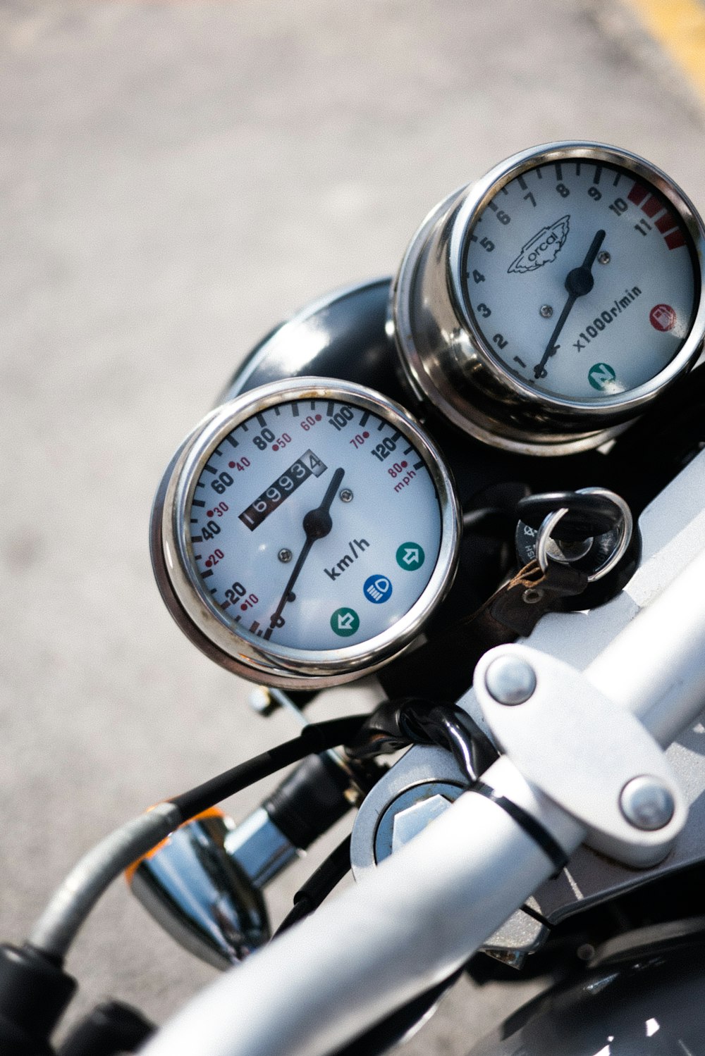 selective focus photography of motorcycle speedometer