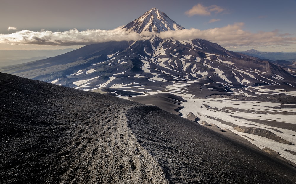 cone-shaped mountain and ice field at daytime