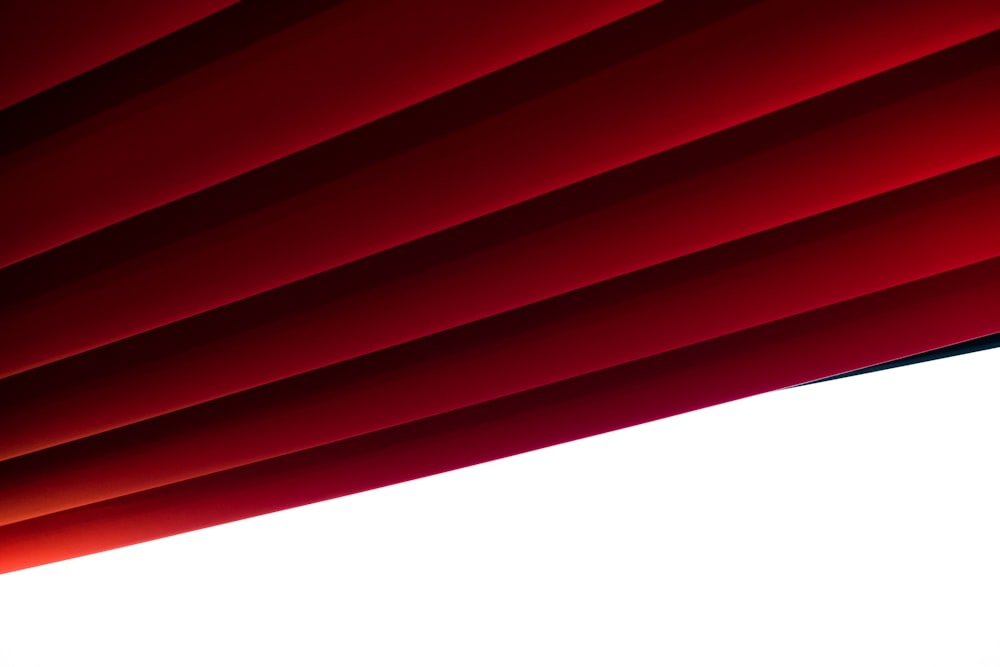 Un primer plano de una cortina roja con un fondo blanco