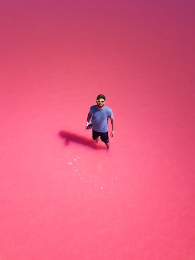 man in purple crew-neck t-shirt wearing sunglasses and cap