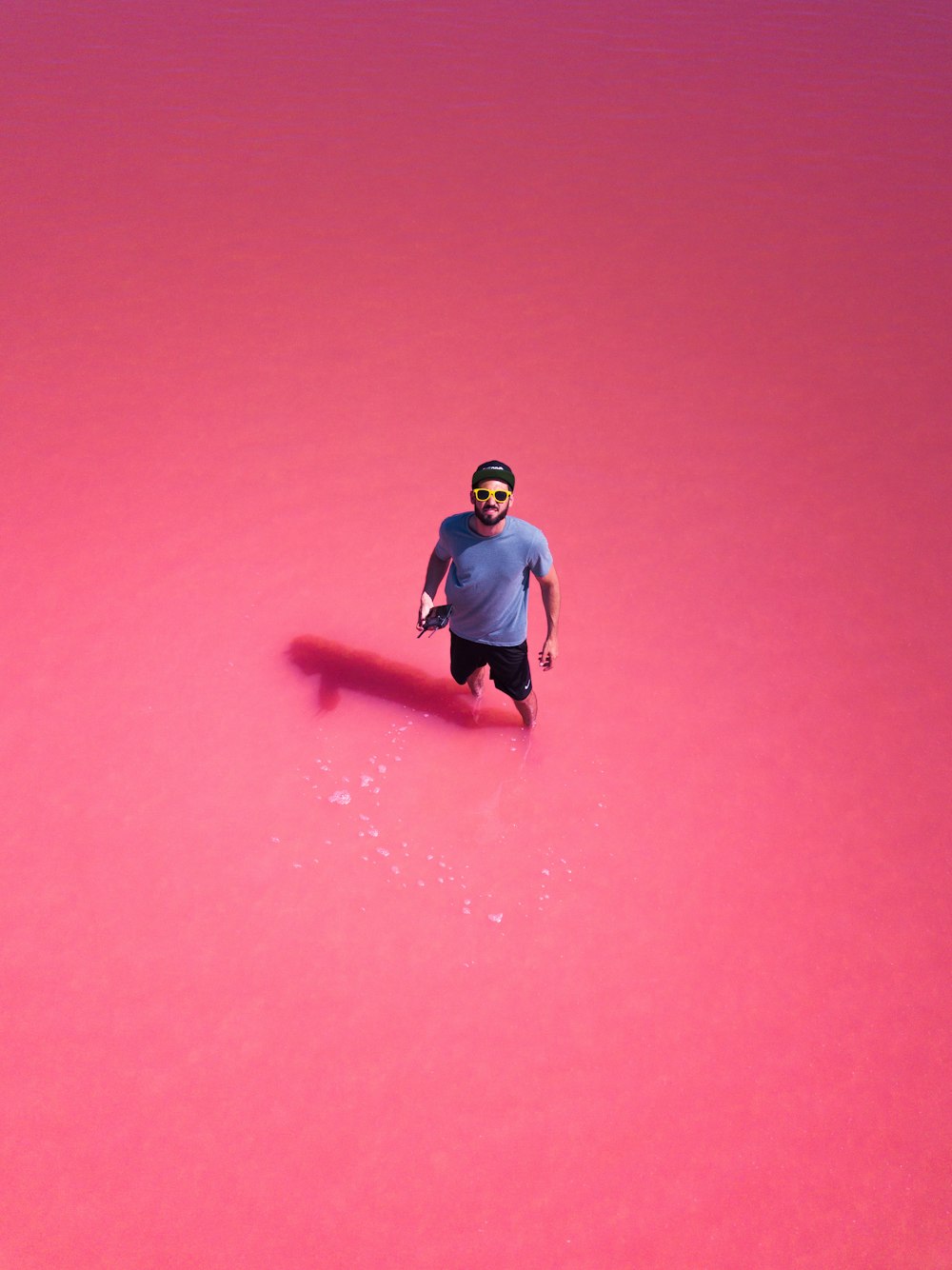 man in purple crew-neck t-shirt wearing sunglasses and cap