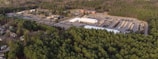 Aerial shot of a secondary mining area surrounded by green forest.