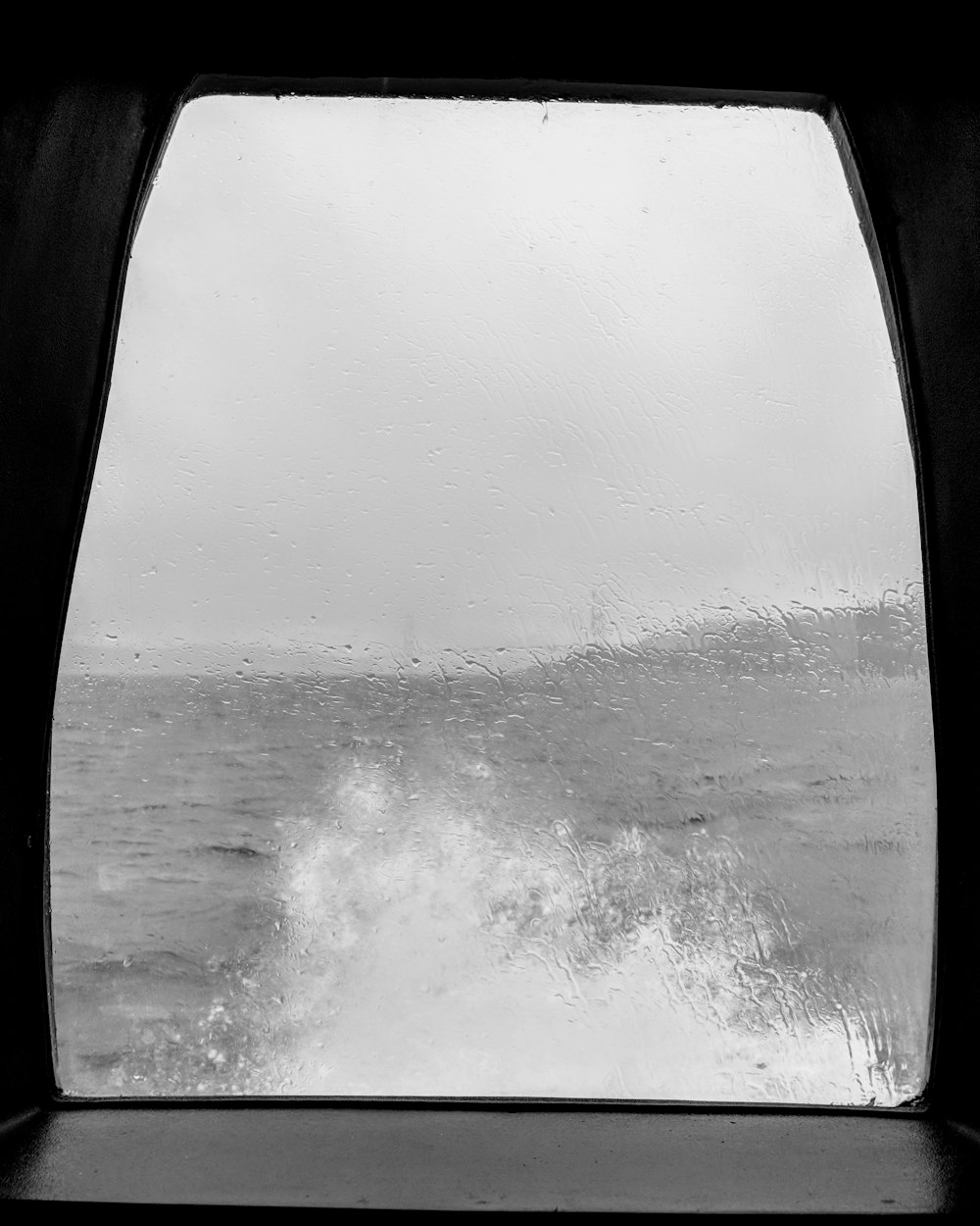 sea waves splashing trough boat window