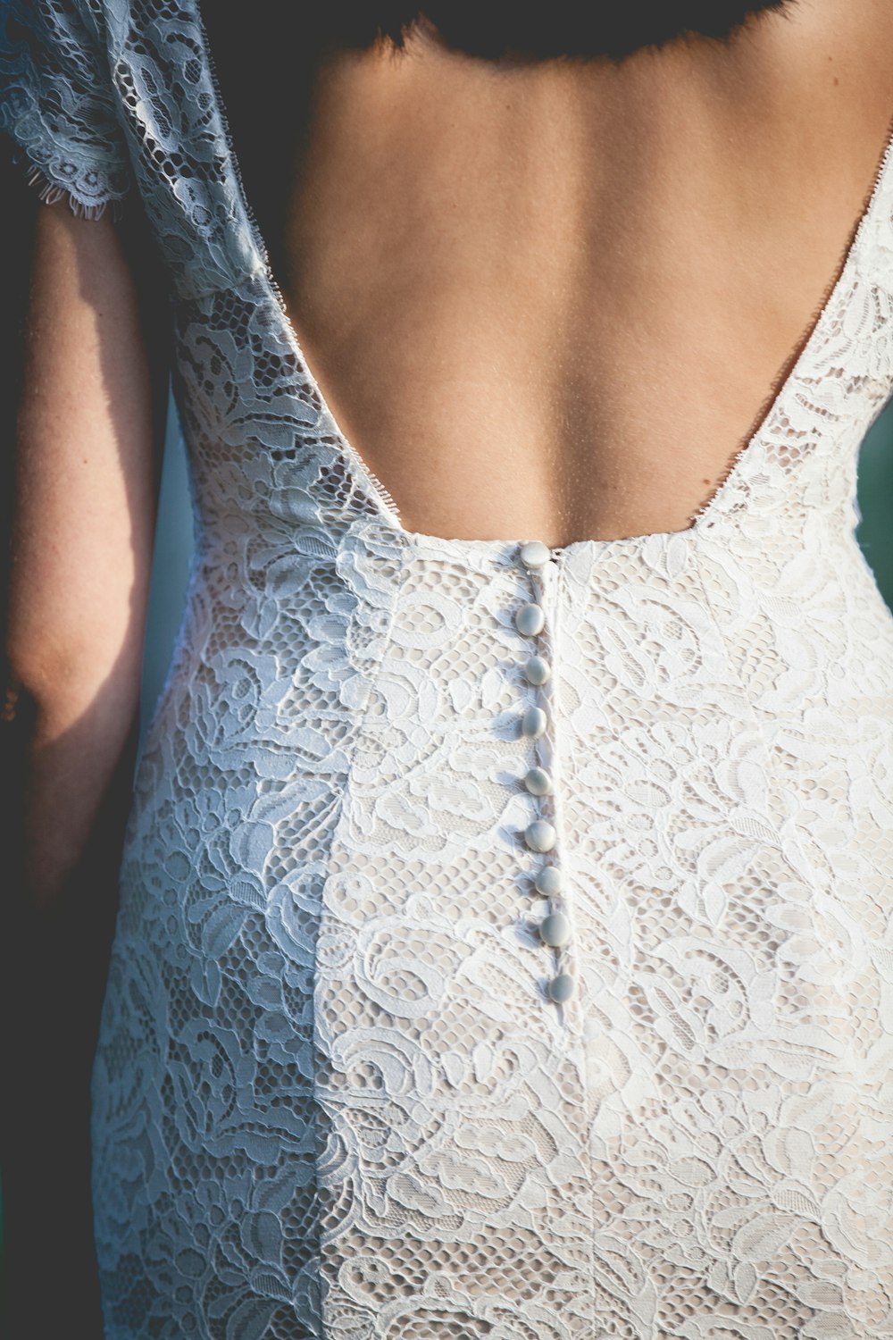 the back of a woman's dress with buttons