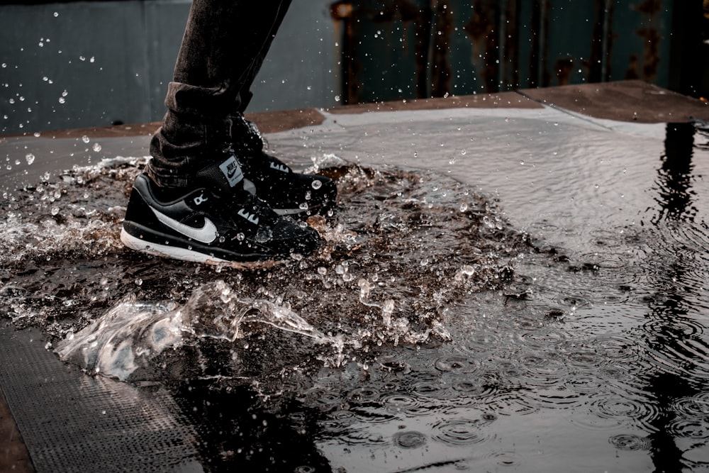 man splashing water on ground