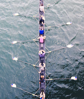 Athletes practicing synchronized swimming moves, demonstrating teamwork and grace in the water.