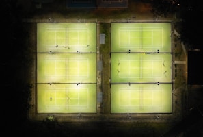 Evening shot of the courts lit up, ready for late matches