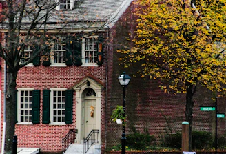 A friendly real estate agent handing keys to a happy family in front of a charming Central Ohio home.
