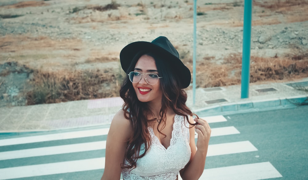 smiling woman standing on road during daytime
