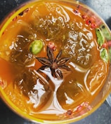 Close-up of a colorful cocktail with vibrant Asian spices and citrus garnish.