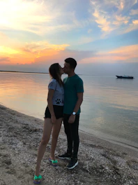 A romantic Latino couple enjoying a sunset cruise in the Caribbean.