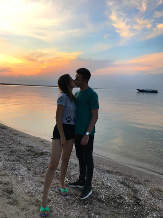 A romantic Latino couple enjoying a sunset cruise in the Caribbean.