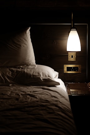 Cozy bedroom with crisp linens, warm lighting, and tasteful decor for restful nights.