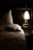 A cozy bedroom setting with soft lighting and romantic decor.