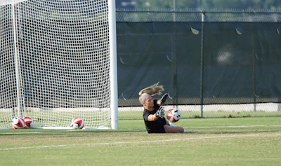 Action shot of a soccer player diving, protected by Fortiguard shin guards.