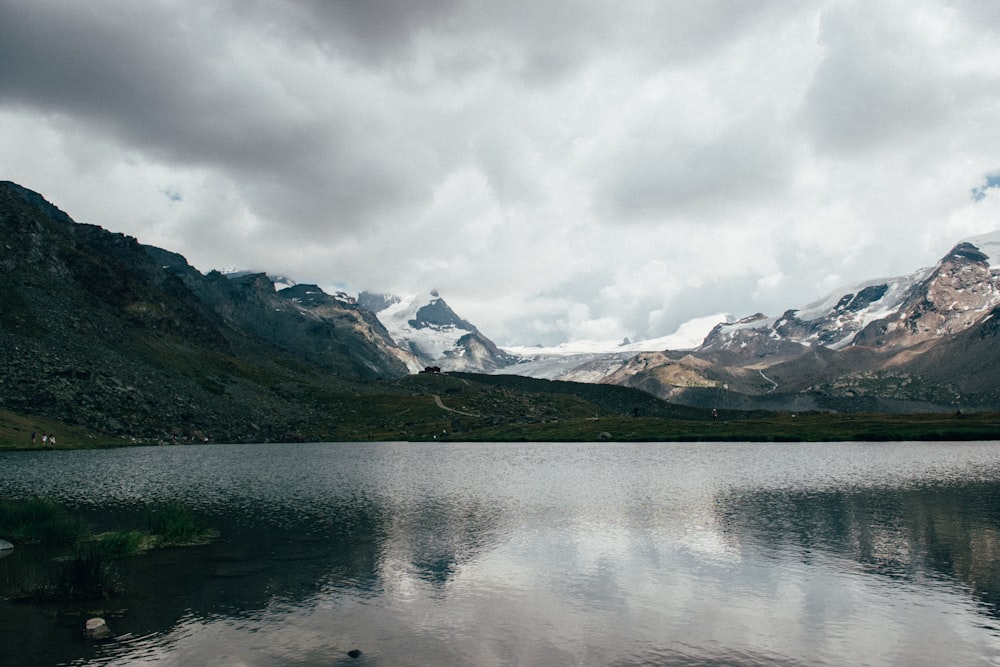 calm body of water and mountain