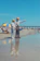 A happy retiree couple enjoying a sunny day at a peaceful beach in Thailand.