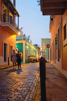 Historic cobblestone streets and vibrant buildings in Lisbon at golden hour.