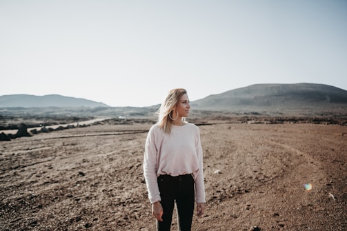 women's white crew-neck long-sleeved shirt, black pants, and silver-colored hoop earrings