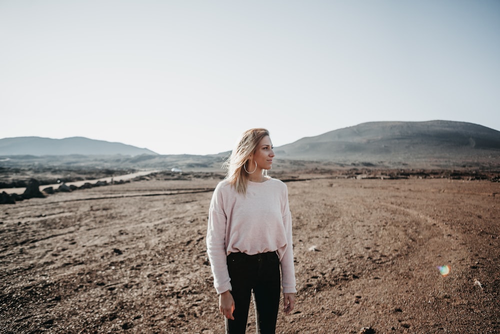 women's white crew-neck long-sleeved shirt, black pants, and silver-colored hoop earrings