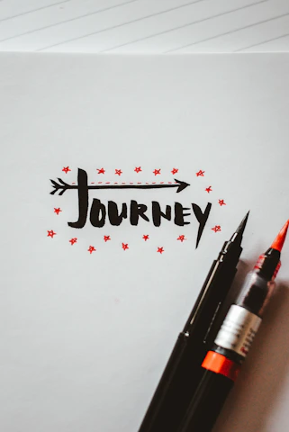 A moody black background with white typing font text overlay representing a writer's creative journey.