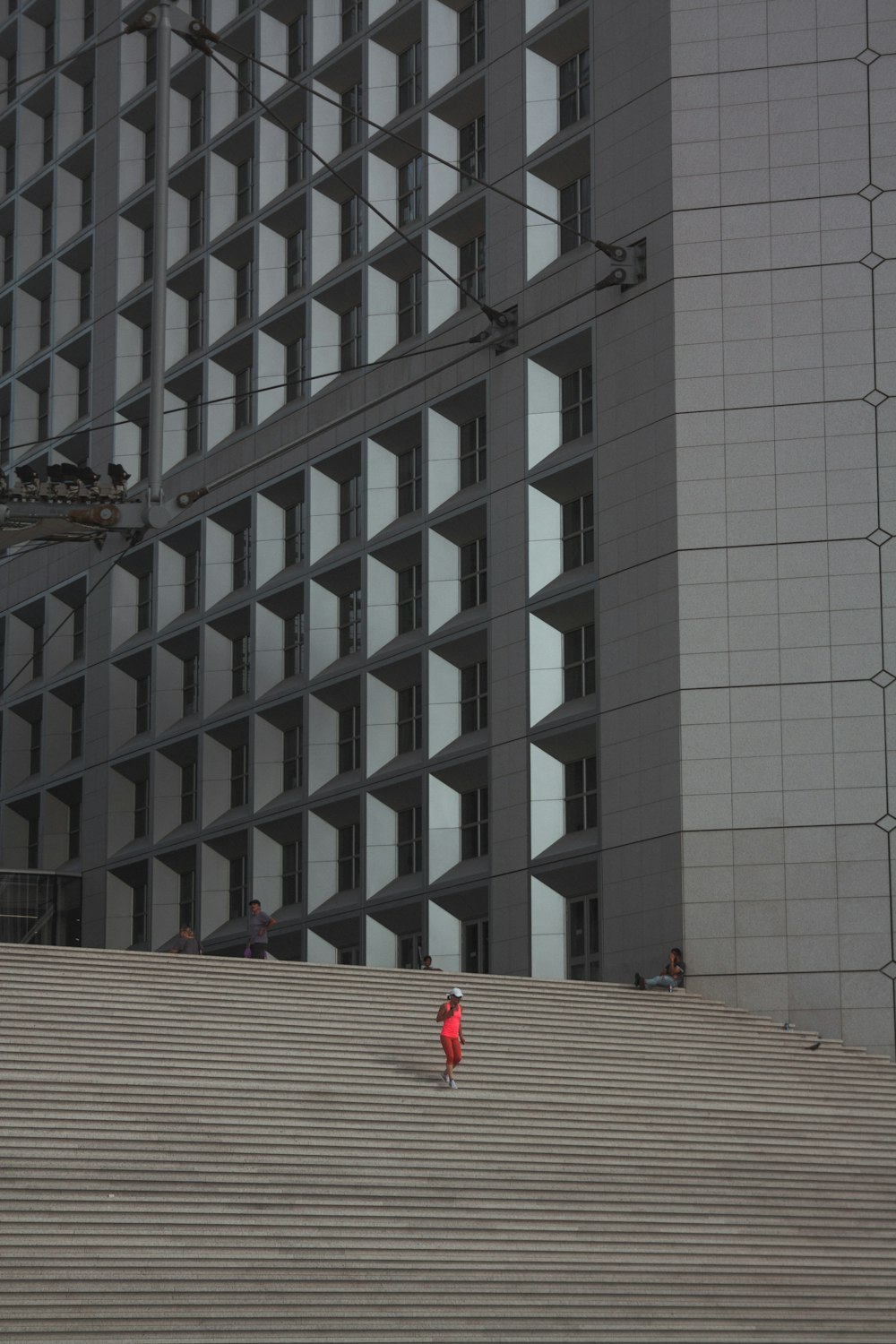 person walking downstairs near concrete building