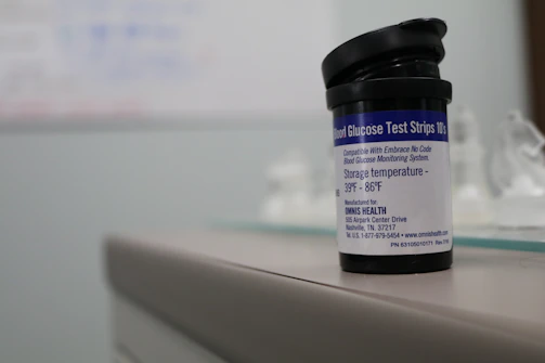 A technician carefully inspecting diabetic test strips in a clean workspace.