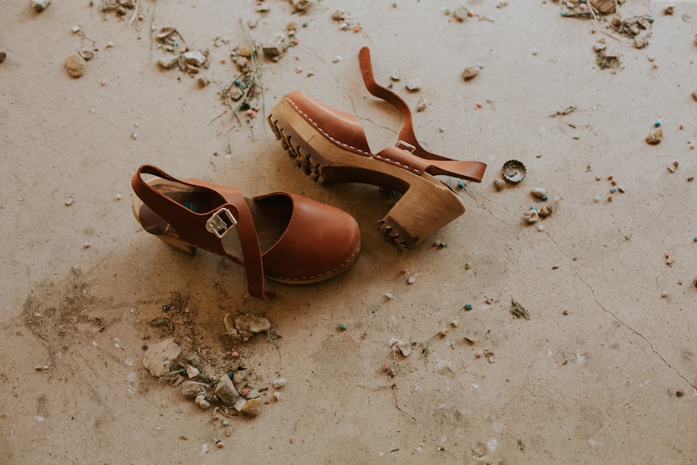 pair of brown ankle-strap sandals on floor