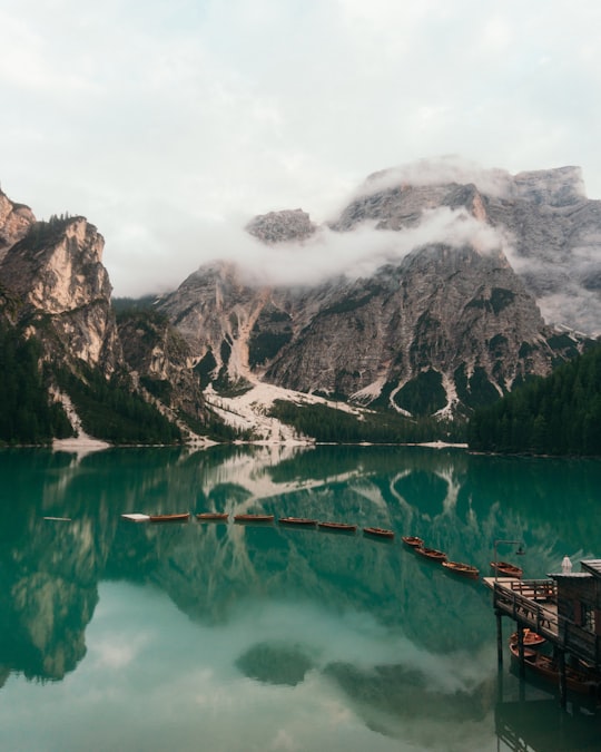 boats on body of water near mountain in Parco naturale di Fanes-Sennes-Braies Italy