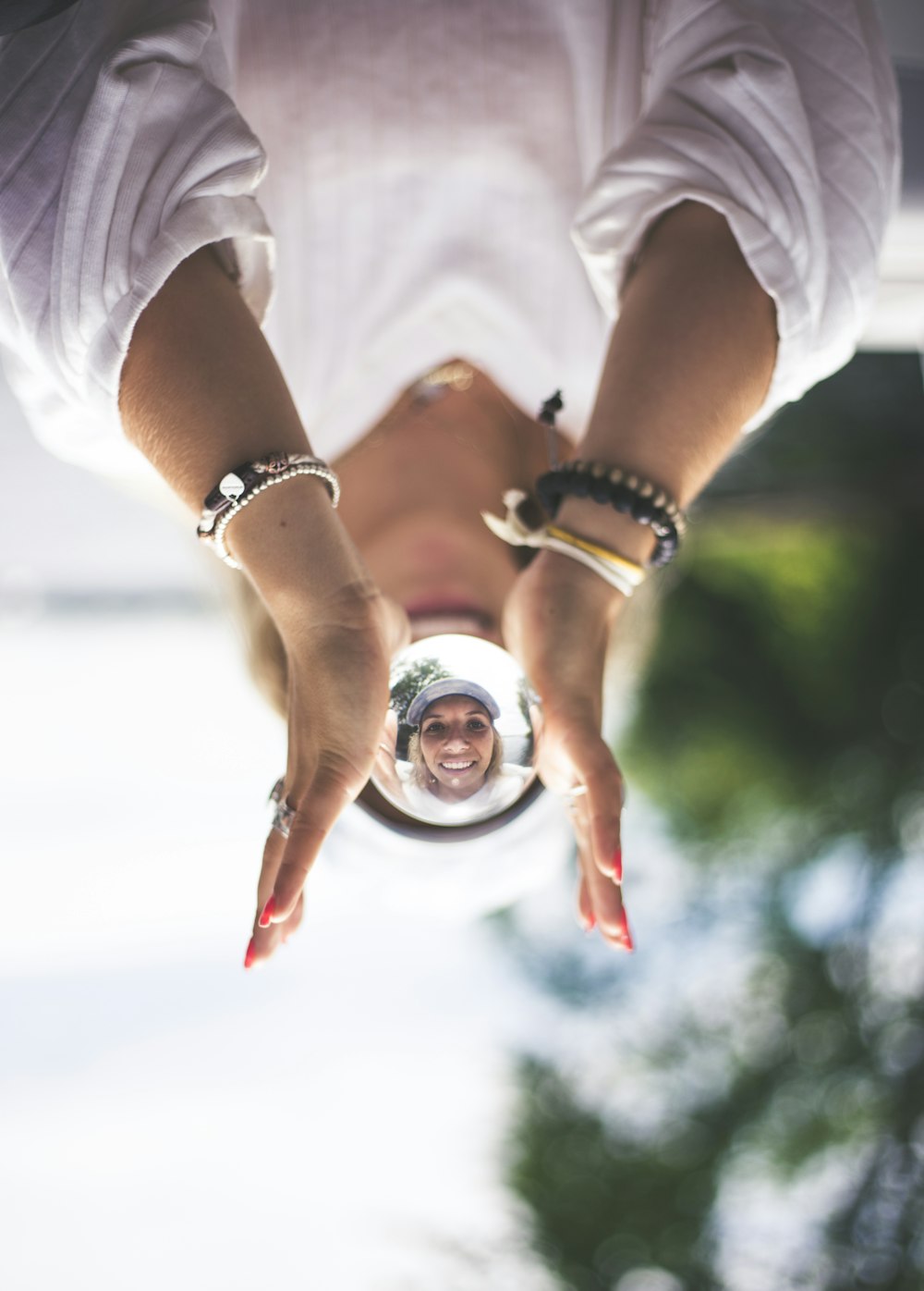 woman in white t-shirt wearing silver round analog watch