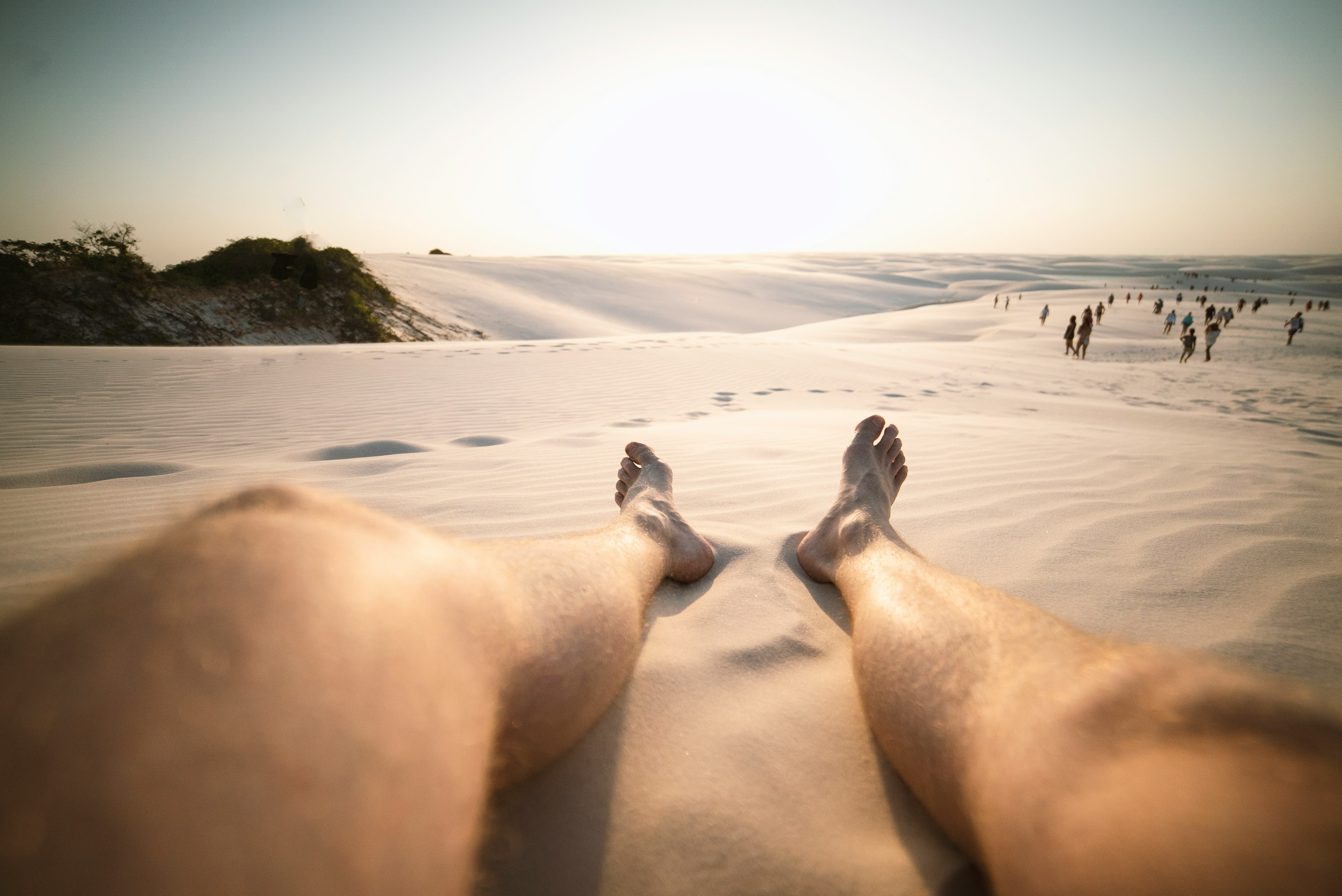 low-angle view of person's feet on sand