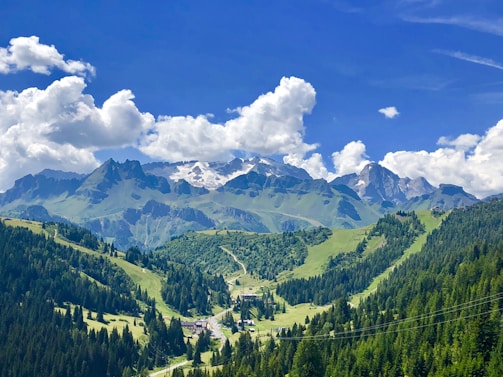 A peaceful mountain resort surrounded by lush greenery and clear blue skies.