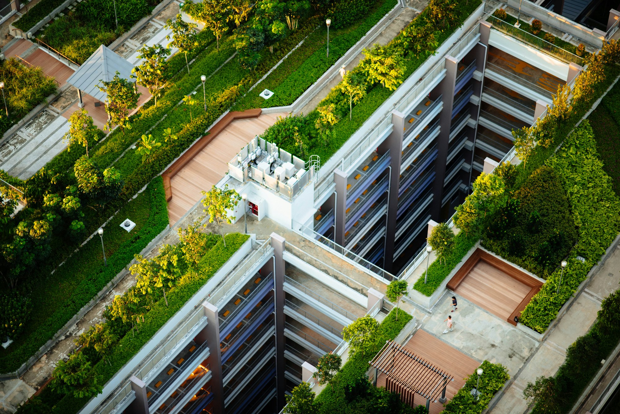 Aerial view of a green building with rooftop gardens