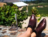 A cozy scene featuring boots and sandals near a window with natural sunlight.