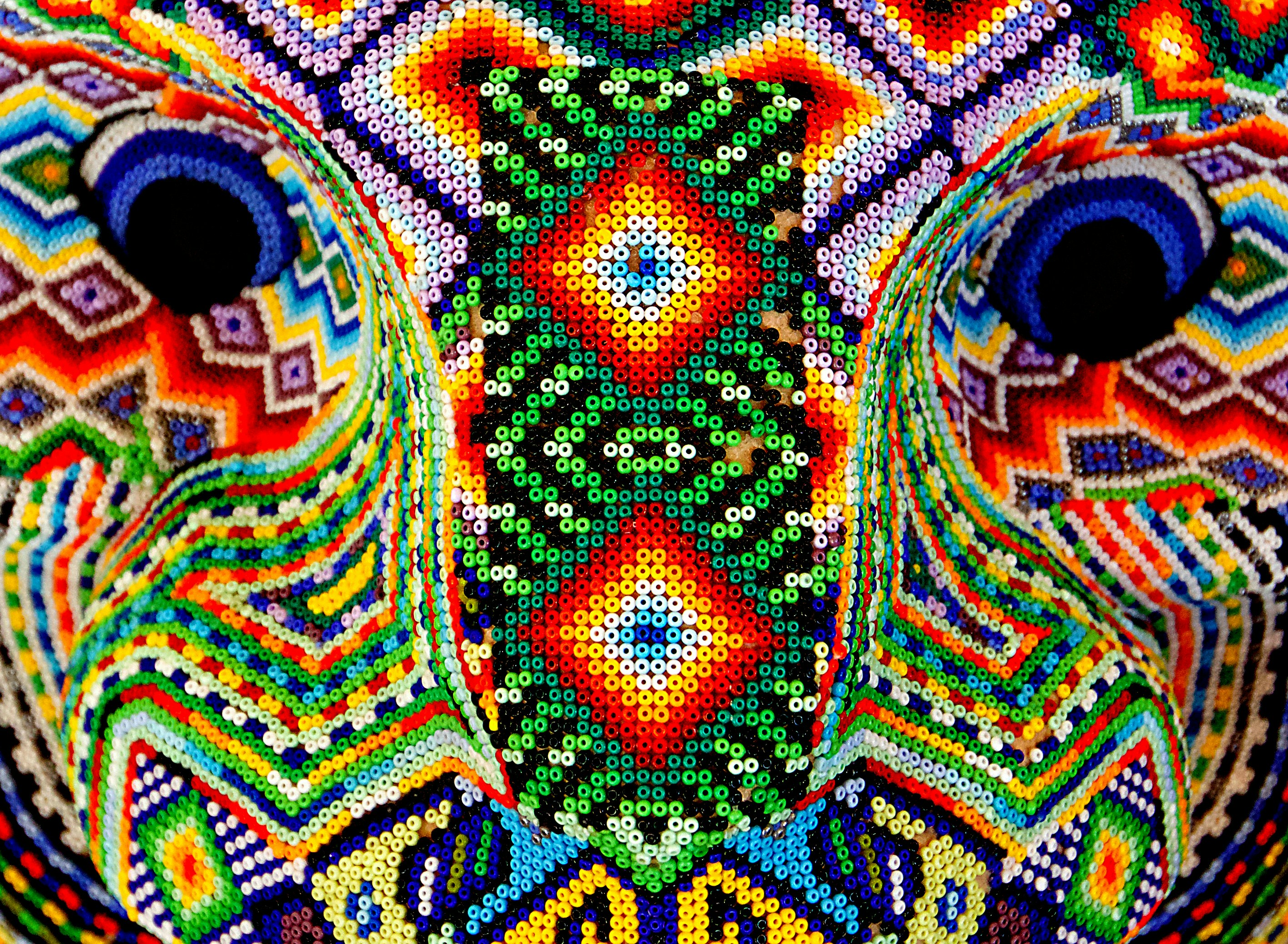 a close up of a colorful elephant's face