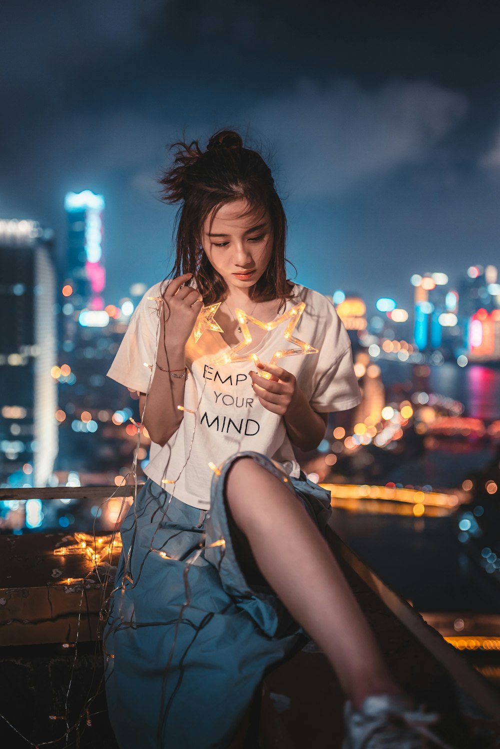 woman holding star-themed string lights