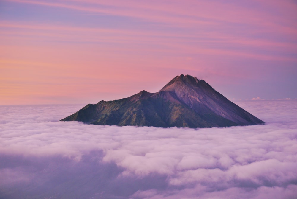 green mountain surrounded with clouds