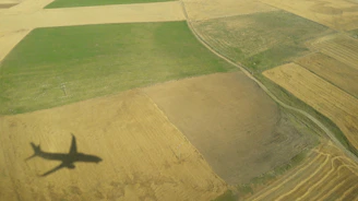 A drone capturing multispectral images over a patchwork of green fields.