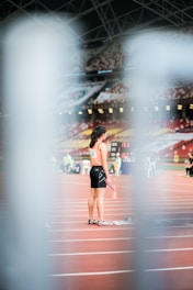 woman standing holding baton