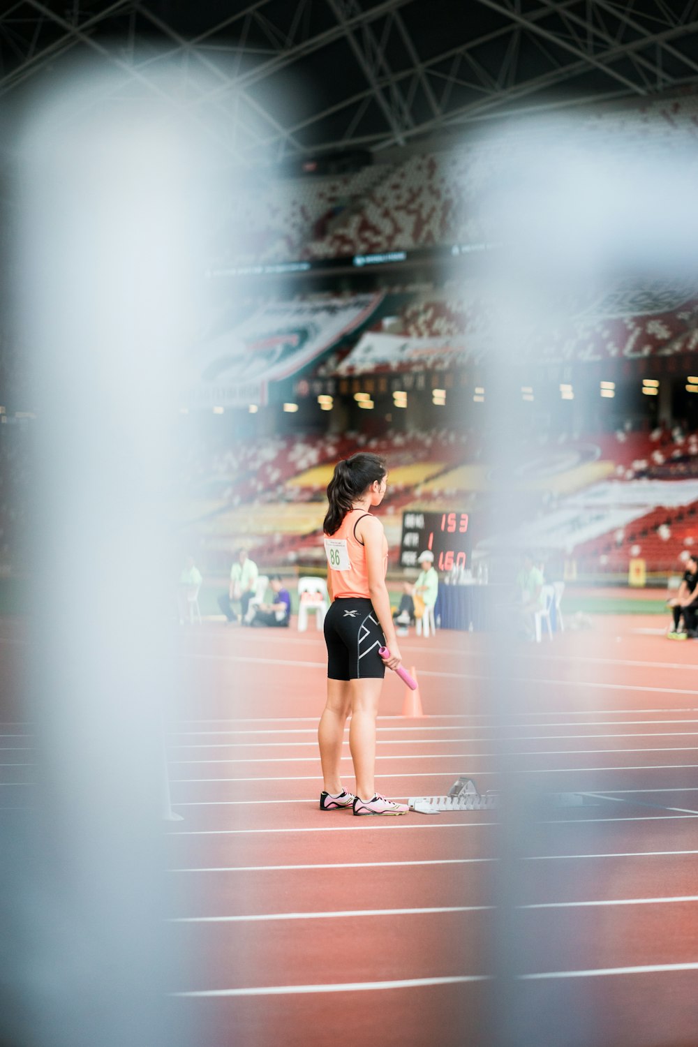 woman standing holding baton