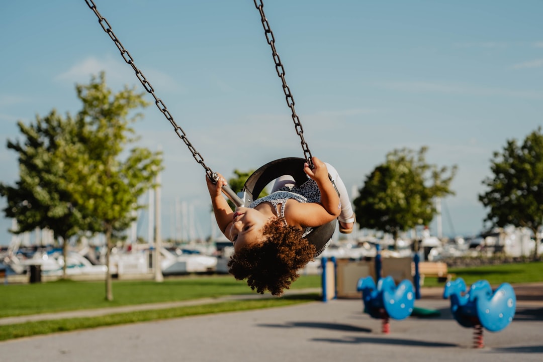 Toddler swinging at the harbor near Burlington, Ontario.