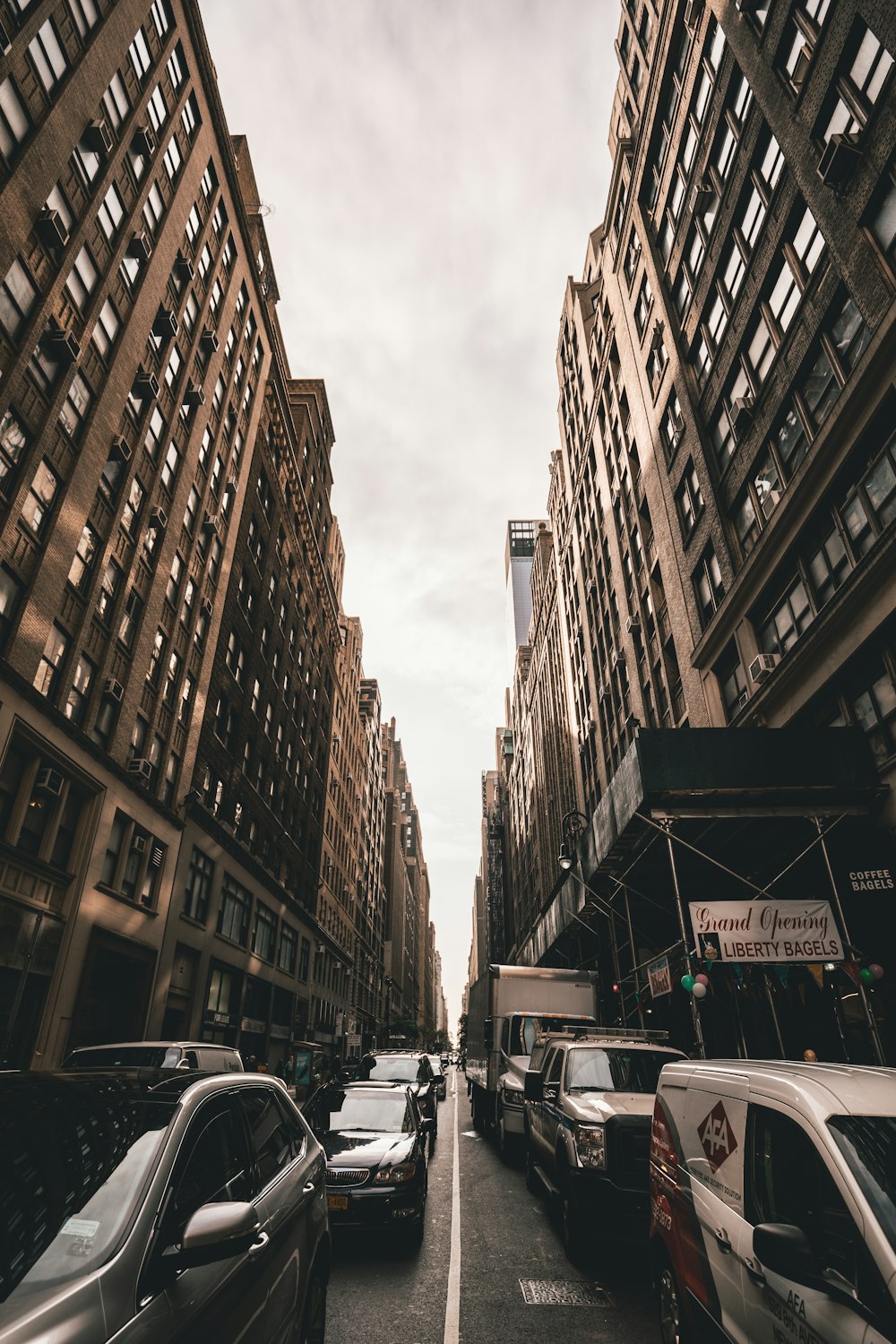 low-angle shot photography of cars between buildings