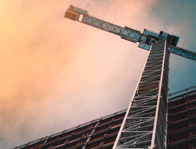 low angle photography of gray tower crane