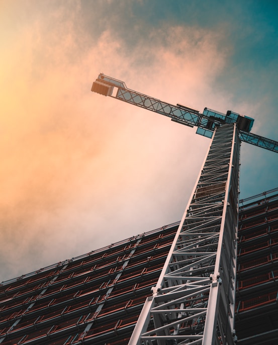 low angle photography of gray tower crane