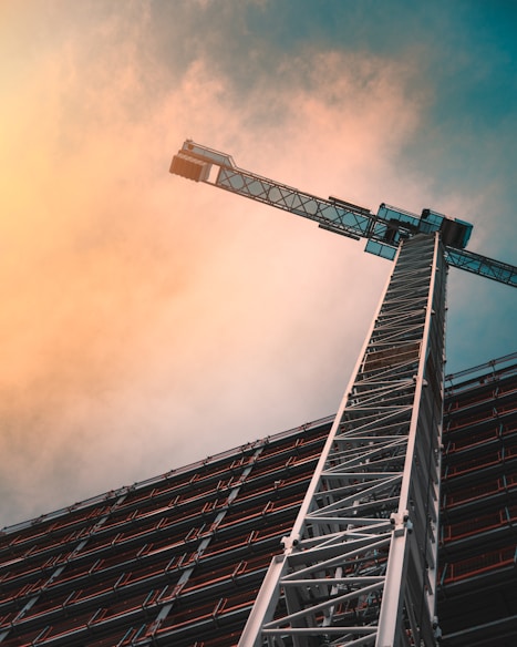 low angle photography of gray tower crane