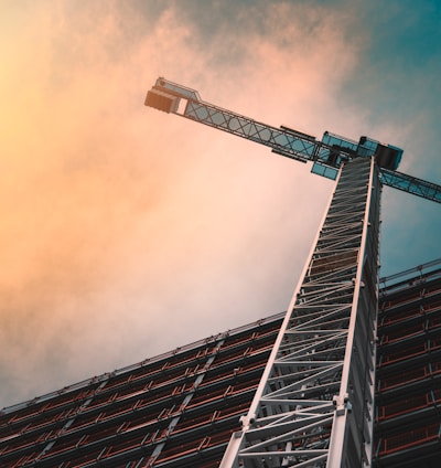 low angle photography of gray tower crane