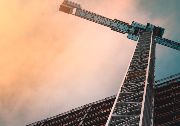 low angle photography of gray tower crane