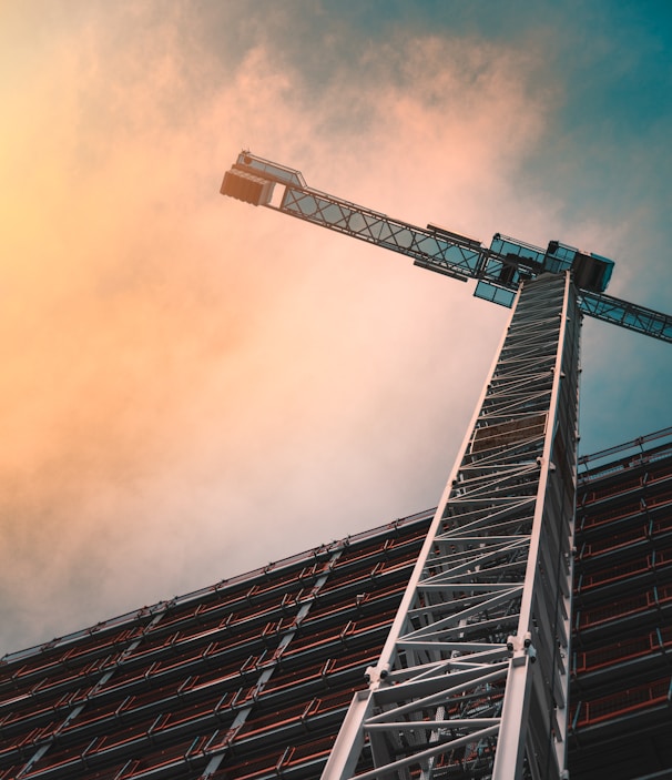 low angle photography of gray tower crane