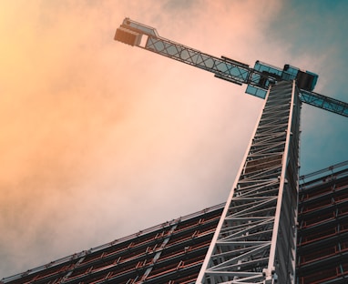 low angle photography of gray tower crane