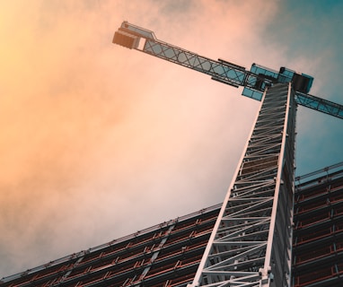 low angle photography of gray tower crane